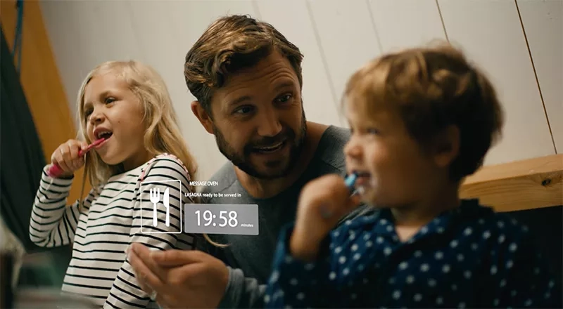 Father instructs kids to brush their teeth while getting instructions from AI regarding his oven dish