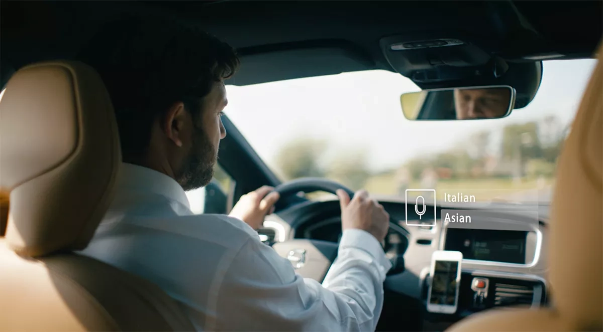 Father is driving while giving voice instructions to his AI companion